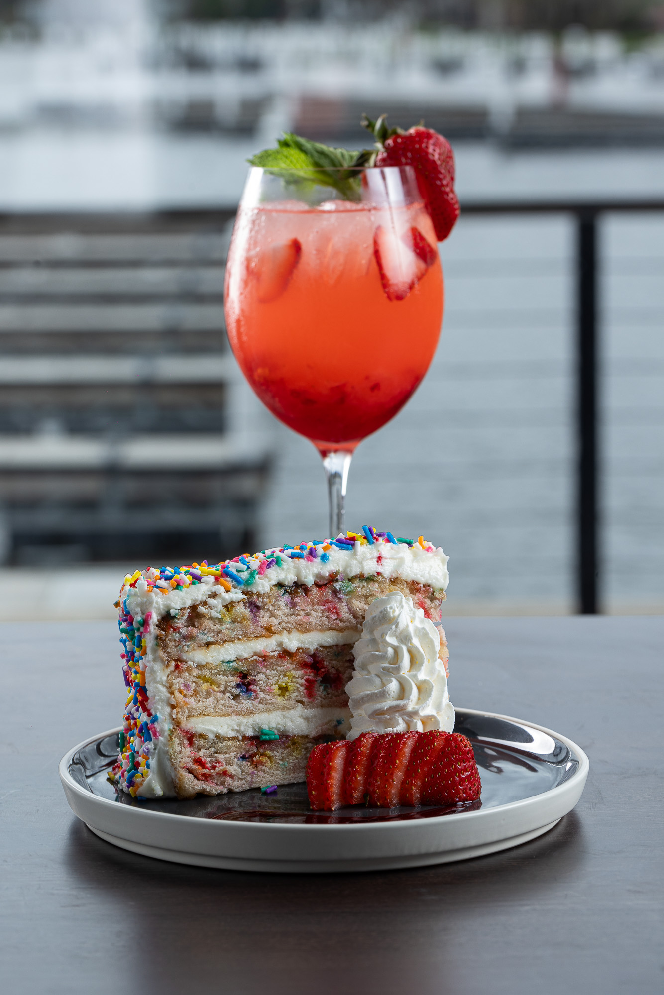 Funfetti cake slice with a strawberry cocktail