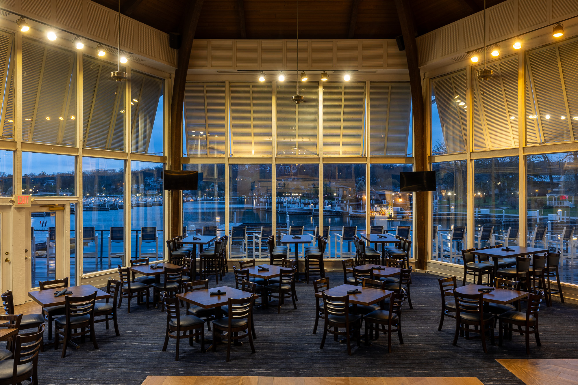 Waterfront dining room with marina views at dusk